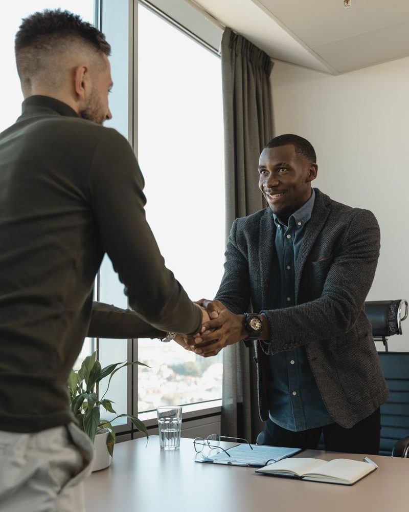 Handshake confirming a new client campaign partnership
